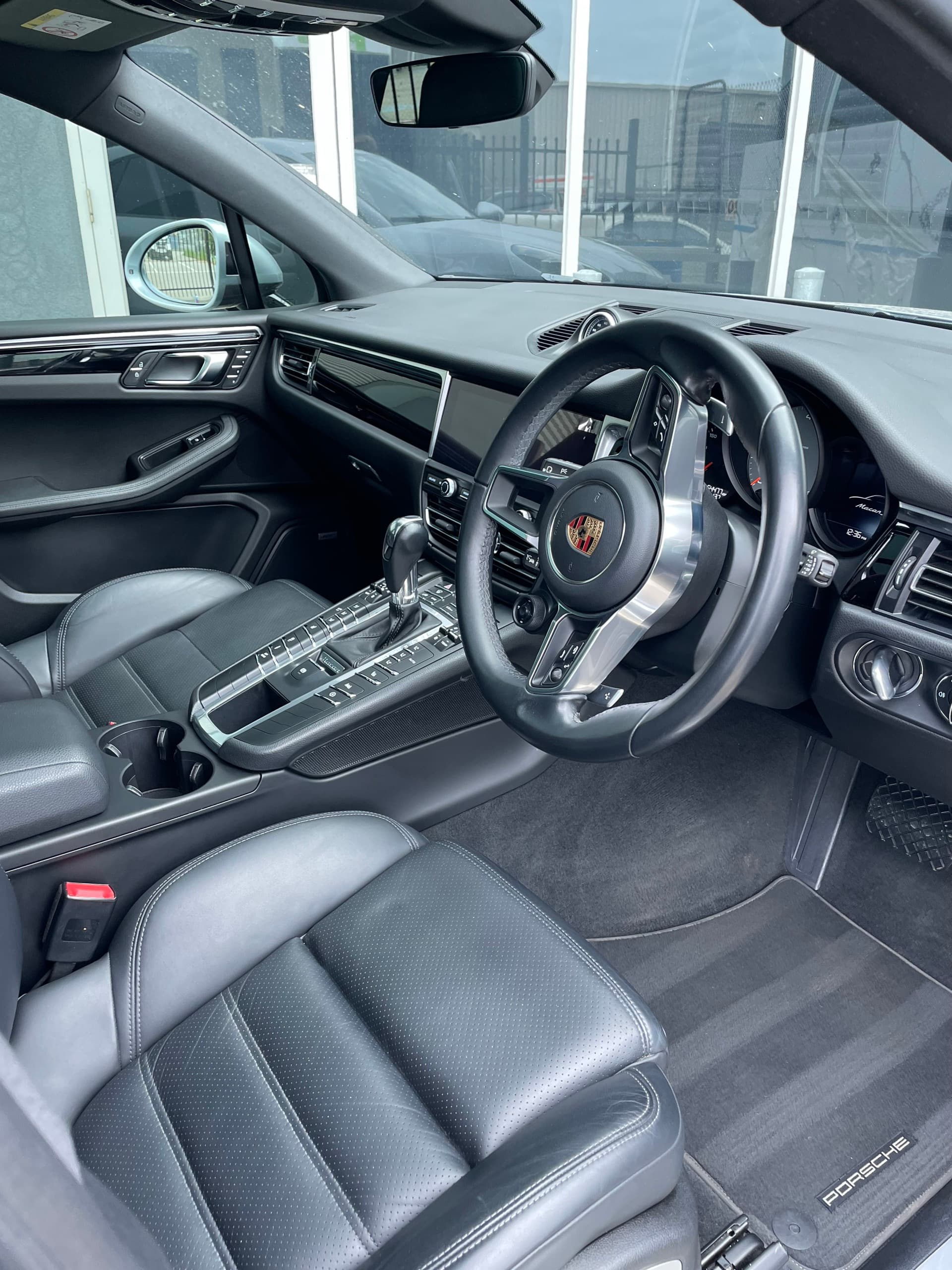 Porsche Macan interior with black leather seats, centre console and steering wheel