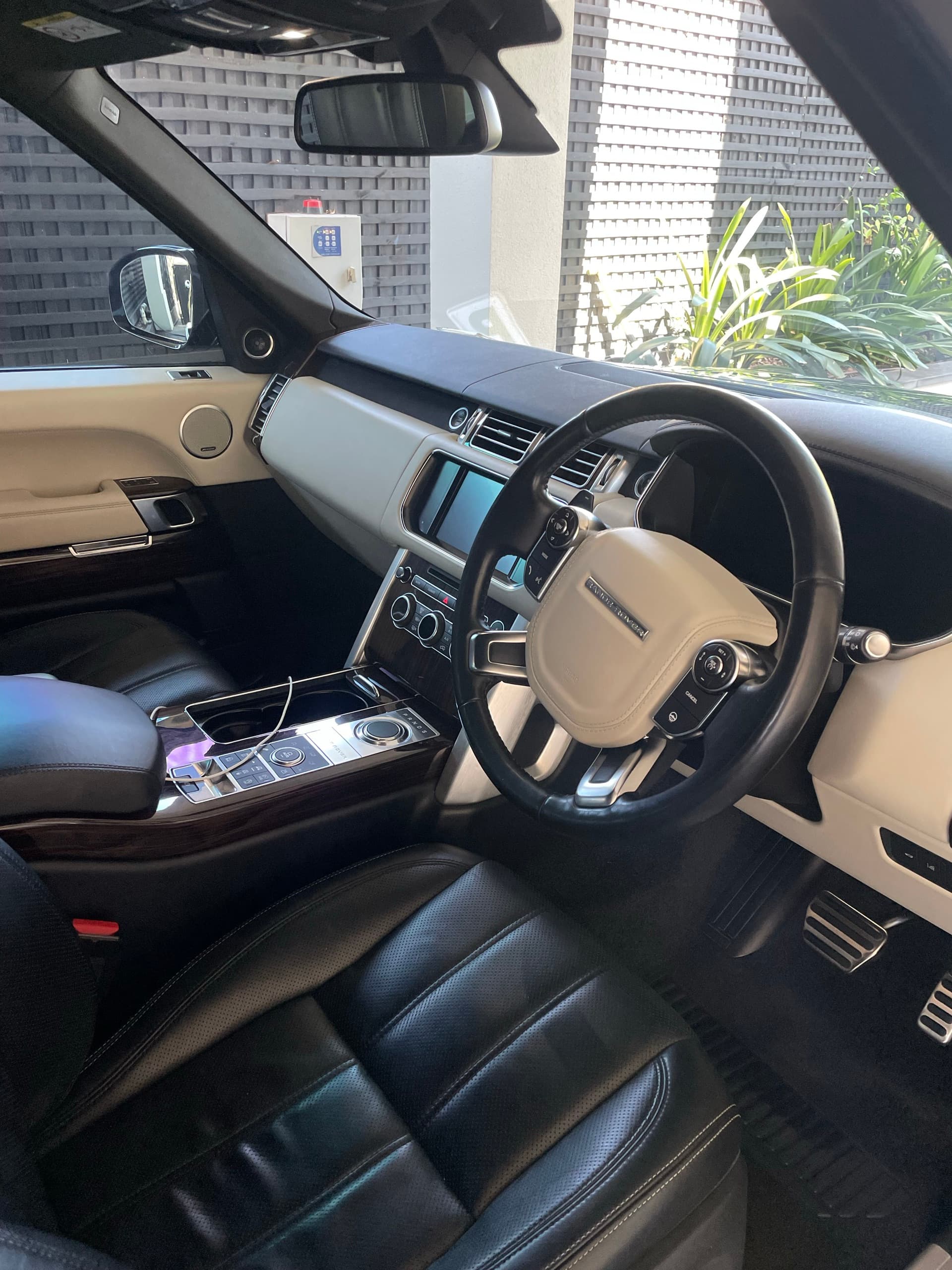Range Rover interior with black leather seats and a cream dashboard